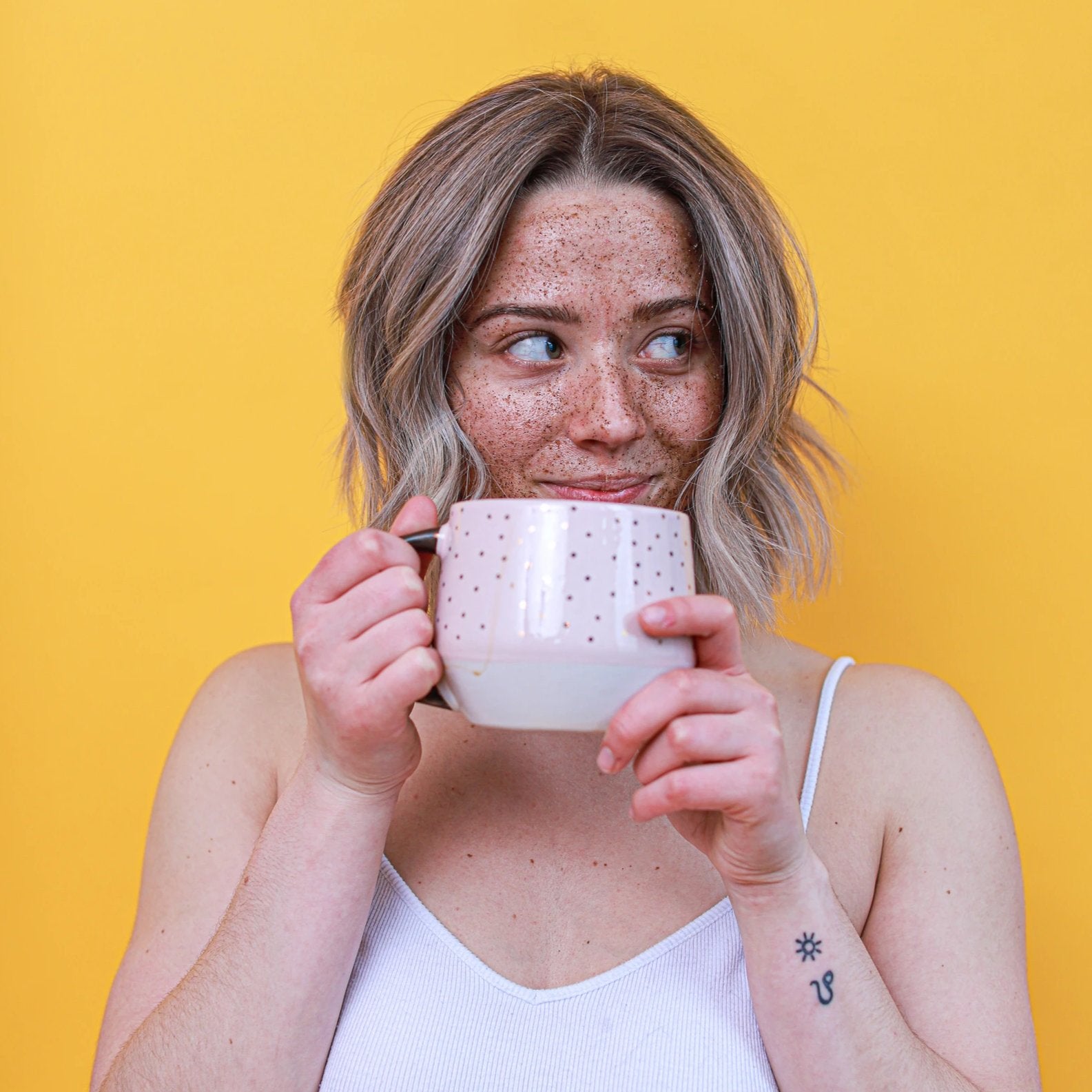 Woman exfoliating with Midtown Village Face & Lip Scrub